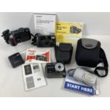 A box of assorted cameras and accessories to include Olympus, Nikon and Pentax.