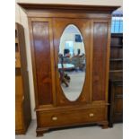 An Edwardian satin wood single door wardrobe with maple panels and inlaid detail. In 3 sections,