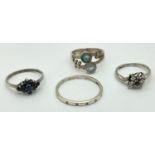 4 stone set silver dress rings. A silver band set with 5 small round cut clear stones, a band ring