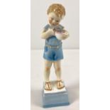 A late 1930's Royal Worcester porcelain figurine of a small boy with his kitten. Model No. 3261