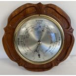 A vintage Shortland Bowen Instruments Ltd wall hanging barometer, in a carved wooden wall hanging