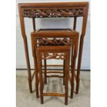 A set of 3 Oriental carved nesting tables with shaped legs and cherry blossom and bird pierced