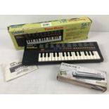 A boxed vintage 1980's Casio SA-1 Tone Bank battery operated keyboard. Together with a boxed