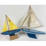 2 vintage Star Production pond yachts. A Blue and white with yellow sails SY2 and a blue with