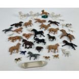 A collection of vintage plastic horse figures in varying colours, to include examples by Britains.