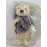 A 13" Steiff pale blonde mohair, fully jointed 'Winter 1997' teddy bear with growler. Wearing tartan