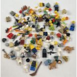 A tub of assorted Lego minifigure parts and accessories. Includes: hats, weapons, animals, heads and