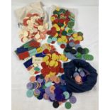 A large quantity of assorted vintage gaming tokens, in varying colours and sizes.