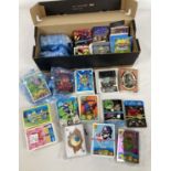 A box of assorted trading cards. To include: Topps Moshi Monsters, Dinosaur King, Panini Bin