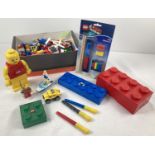 A collection of loose Lego and Lego merchandise. To include: Lego man torch, key ring torch, brick