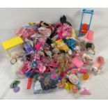 A large collection of Barbie clothes and accessories. To include strollers, nursery items, shoes and