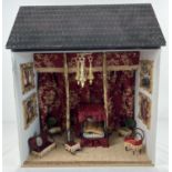 A vintage wooden open fronted dolls house furnished as a made up room in red & gold colours. With