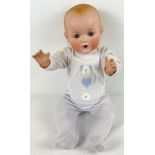 An Armand Marseille bisque headed 25" doll with composite body and limbs. With sleep eyes, painted