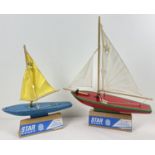 2 vintage Star Productions "Star Yacht" pond yachts. A blue and yellow SY1 together with a red and