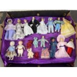 12 assorted bisque headed dolls house dolls in handmade outfits, in varying sizes. Together with 2