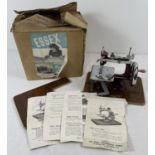 A boxed vintage Essex Miniature sewing machine complete with bed extension, clamp and