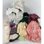 A box of assorted vintage dolls clothes. To include 3 pieces skirt suits and a wooden chest of white