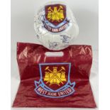 A size 5 West Ham United signed football with official West Ham carrier bag.