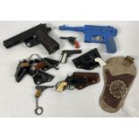 A collection of assorted vintage toy guns, key rings and holsters. To include: Lone Star, Victory