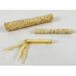 2 antique ivory highly carved needle cases together with a pocket manicure/vanity tool. Largest case