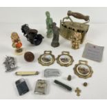 A box of assorted vintage misc items to include lighters, ceramic Hummel figurine, penkinfe, brass