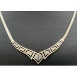 A vintage fixed pendant necklace with Greek key design. Silver marks to back of pendant. Total