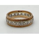 A 9ct gold full eternity ring set with a row of cubic zirconias and with diamond cut detail.