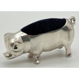 A small silver pin cushion in the shape of a pig. Underside of pig marked 925. Approx. 2 x 4cm.