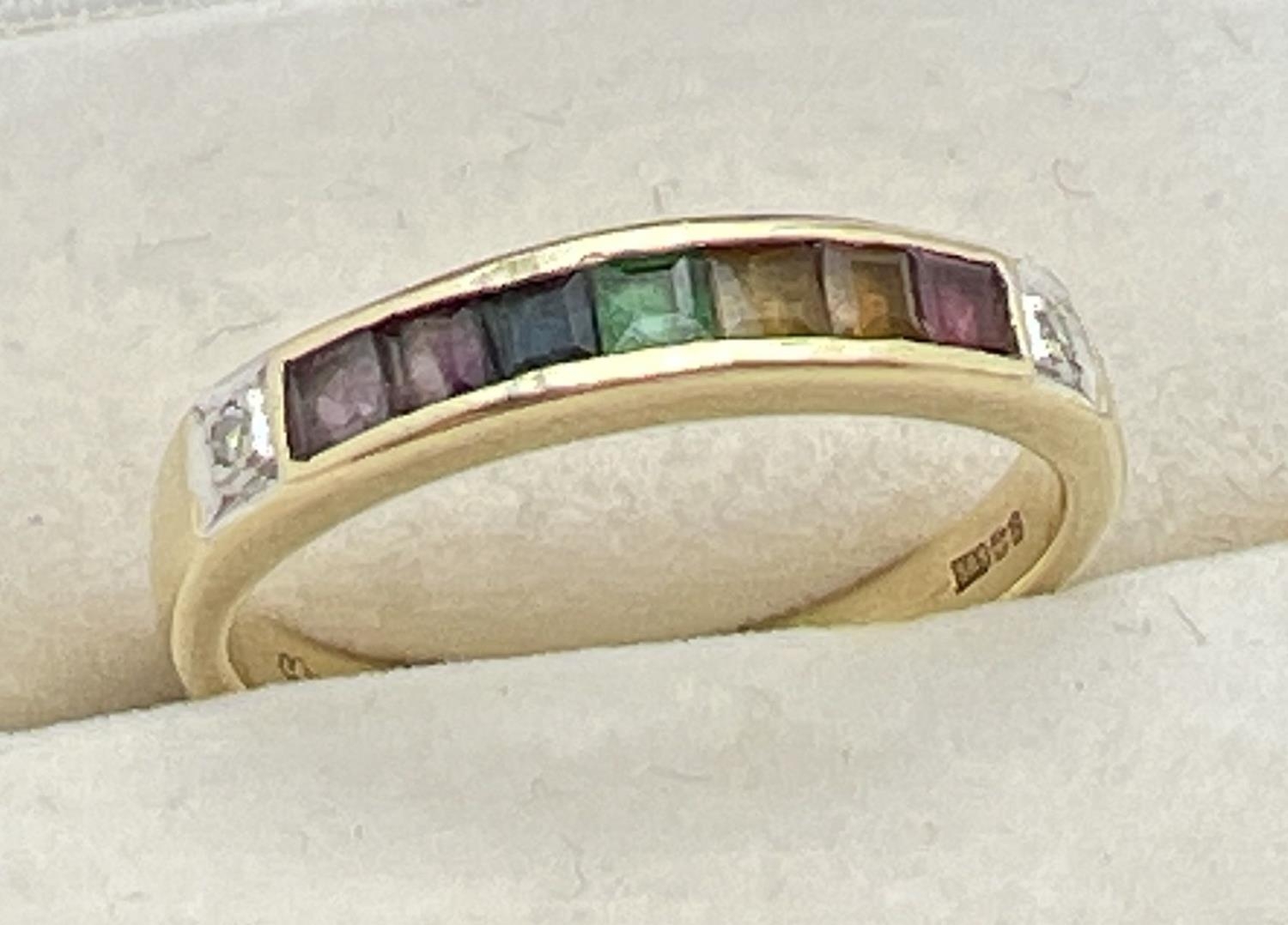 A 14ct gold ring set with 7 square cut channel set rainbow gemstones and flanked by diamonds. - Image 4 of 4