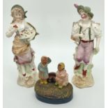 A pair of continental ceramic figurines together with a vintage French pottery souvenir ornament