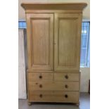 A 19th century pine 3 sectional linen press wardrobe with original knob handles. 2 door cupboard has