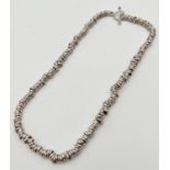 A silver sweetie style necklace with T bar clasp. Approx. 16 inch long. Silver marks to clasp. Total