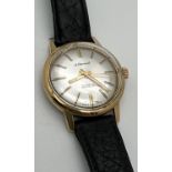 A vintage style men's wristwatch by Le Cheminant. Gold tone case with silver face, gold tone hour