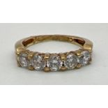A 9ct gold half eternity ring set with 5 round cut Cubic Zirconia's. Fully hallmarked inside band