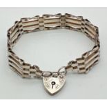 A vintage silver 4 bar gate bracelet with padlock clasp and safety chain. Hallmarked for London