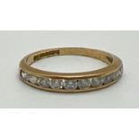 A 9ct yellow gold half eternity ring with channel set round cut clear stones. Fully hallmarked