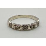 A 9ct white gold half eternity style ring, set with small clusters of round cut diamonds. One