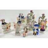 A collection of antique Staffordshire figures and toby jugs in varying styles, sizes and conditions.