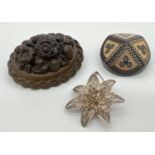 3 vintage brooches. An oval shaped bog oak brooch with carved floral design, a white metal