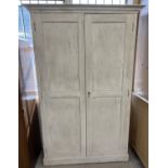 An antique solid oak 2 door cupboard with interior shelving, used as an old school ink cupboard.