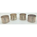 A set of 4 Thai silver napkin rings with Thai deity decoration to front. Each napkin marked "