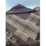 A 20th century brown and beige hand woven throw with tasselled edge.
