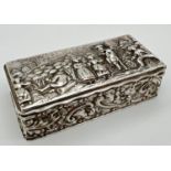 An Edwardian silver rectangular shaped repousse trinket box with hinged Lid. Of scroll and foliate