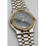 A ladies two tone stainless steel bracelet wrist watch by Gucci. Black face with gold tone hands.