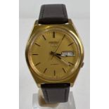 A 1998 Seiko 5 automatic wristwatch 7S26-3140 870562. Gold tone case and face with black hour