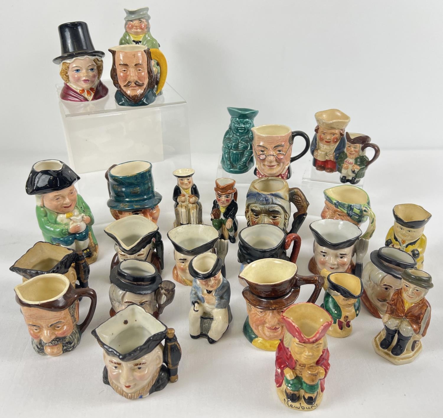 A collection of 28 assorted miniature and small sized ceramic character jugs. To include: