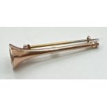 A vintage 9ct gold brooch in the shape of a hunting horn. Back pin and safety chain not gold.