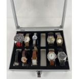 A metal and perspex watch display case containing 10 varying style wristwatches to include