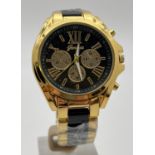 A new, with original wrap, mens gold tone and black link chronograph wrist watch by Geneva. Luminous