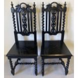 A pair of Victorian carved dark oak barley twist hall chairs. With foliate carved detail to backs,